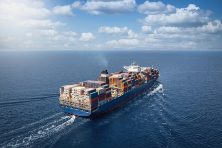 A large container cargo ship in motion at sea